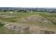 Expansive grassy land with scattered homes and a road running through the landscape at 1740 Michael Gates Dr, Parker, CO 80138