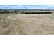 A serene landscape view shows rolling land with sparse vegetation, tree line, and distant community at 1740 Michael Gates Dr, Parker, CO 80138
