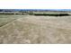 Rolling land with sparse vegetation, marked by tire tracks and a distant tree line, under a clear sky at 1740 Michael Gates Dr, Parker, CO 80138