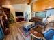 Comfortable living room with a brick fireplace, wood-style flooring, and a cozy seating arrangement at 1740 Michael Gates Dr, Parker, CO 80138