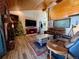 Cozy living room with a brick fireplace, wood floors, and stylish decor at 1740 Michael Gates Dr, Parker, CO 80138