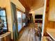 Inviting living room with wood floors, brick fireplace, and vaulted wood ceiling, leading to an outdoor deck at 1740 Michael Gates Dr, Parker, CO 80138