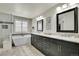 Luxurious bathroom featuring a dual sink vanity, standalone tub, and tiled shower at 2889 Windridge Cir, Highlands Ranch, CO 80126