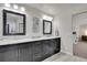 Bathroom featuring dual sinks, granite countertop, and dark wood cabinets at 2889 Windridge Cir, Highlands Ranch, CO 80126