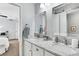 Bright bathroom featuring dual sinks, granite countertop, and modern decor at 2889 Windridge Cir, Highlands Ranch, CO 80126