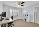 Bedroom with large window, carpet, ceiling fan and a home office at 2889 Windridge Cir, Highlands Ranch, CO 80126