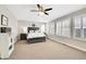 Spacious bedroom with large windows, a ceiling fan, plush carpet, and comfortable furnishings at 2889 Windridge Cir, Highlands Ranch, CO 80126