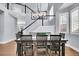 Close-up of dining table with view of staircase and chandelier, hardwood floors and natural light at 2889 Windridge Cir, Highlands Ranch, CO 80126