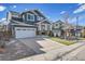 Exterior view of a charming two-story home showcasing its driveway and well-manicured lawn at 2889 Windridge Cir, Highlands Ranch, CO 80126