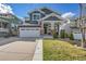 Charming two-story home featuring a manicured front yard and an attached two-car garage at 2889 Windridge Cir, Highlands Ranch, CO 80126