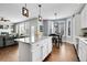 Bright kitchen boasts white cabinets, an island, and flows into the living and dining areas at 2889 Windridge Cir, Highlands Ranch, CO 80126