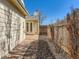 Backyard with stone path, garden bed, and wooden fence at 8322 S Upham Way, Littleton, CO 80128