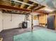 Open basement featuring exposed duct work, a dark washer and dryer, and open ceilings at 8322 S Upham Way, Littleton, CO 80128