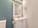 Bathroom with white vanity, bright mirror, and teal accent wall at 8322 S Upham Way, Littleton, CO 80128