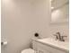 Bathroom with white vanity, toilet, and sink at 8322 S Upham Way, Littleton, CO 80128
