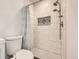 Modern bathroom with white tiled shower and decorative mosaic tile accent at 8322 S Upham Way, Littleton, CO 80128