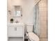 Bathroom with white vanity and tiled shower at 8322 S Upham Way, Littleton, CO 80128