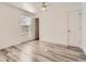 Bedroom with wood look flooring, large windows, and neutral paint at 8322 S Upham Way, Littleton, CO 80128