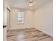 Sunlit bedroom with a ceiling fan, light gray wood floors, baseboard trim, and a closet with sliding doors at 8322 S Upham Way, Littleton, CO 80128