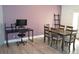Dining room and desk area with wood table, chairs, and purple accent wall at 8322 S Upham Way, Littleton, CO 80128