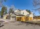 Townhouse showing beige siding, light trim, gray roof, and two garage doors at 8322 S Upham Way, Littleton, CO 80128