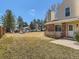 Townhouse with brick accent, chimney, and landscaped front yard offering parking and community feel at 8322 S Upham Way, Littleton, CO 80128
