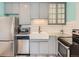 Updated kitchen featuring stainless appliances, granite countertops, and farmhouse sink at 8322 S Upham Way, Littleton, CO 80128