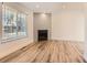 Modern living room with hardwood floors, a contemporary fireplace, and abundant natural light at 8322 S Upham Way, Littleton, CO 80128
