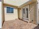 Outdoor patio area with brick pavers and door to the house at 8322 S Upham Way, Littleton, CO 80128