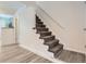 Carpeted stairway with gray wood-look floors at 8322 S Upham Way, Littleton, CO 80128