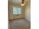 Simple bedroom featuring a window and neutral walls and carpet, offering a blank canvas at 1450 Albion St # 206, Denver, CO 80220