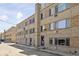 Exterior view of the building featuring multiple windows and access doors with parking available at 1450 Albion St # 206, Denver, CO 80220