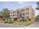 Apartment building exterior showcasing a brick facade, well-maintained landscaping, and clear signage at 1450 Albion St # 206, Denver, CO 80220