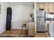 Cozy kitchen space with a stainless steel refrigerator and a small island with seating at 1450 Albion St # 206, Denver, CO 80220