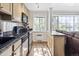 The kitchen and living room showcases stainless appliances and views from a large window at 1450 Albion St # 206, Denver, CO 80220