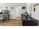 Bright living area featuring a work space, TV, and hardwood floors at 1450 Albion St # 206, Denver, CO 80220