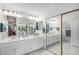 Bright bathroom with double sinks, ample cabinet space, a full mirror, and tiled floors at 1121 W Kettle Ave, Littleton, CO 80120
