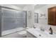 Bathroom featuring a tiled shower-tub combo, modern fixtures, and an updated vanity at 1121 W Kettle Ave, Littleton, CO 80120