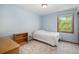 Cozy bedroom with a single bed, window, and neutral carpet, creating a comfortable space at 1121 W Kettle Ave, Littleton, CO 80120