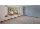 Bedroom with a large window that provides plenty of natural light and neutral carpeting at 1121 W Kettle Ave, Littleton, CO 80120