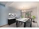 Formal dining room featuring modern chandelier and ample natural light from a large window at 1121 W Kettle Ave, Littleton, CO 80120