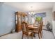 Elegant dining room featuring a china cabinet, dining set, and natural light from the window at 1121 W Kettle Ave, Littleton, CO 80120