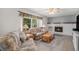 Comfortable living room featuring a fireplace and large window providing ample natural light at 1121 W Kettle Ave, Littleton, CO 80120