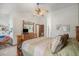 Spacious main bedroom featuring a decorative ceiling fan and a large wood dresser with mirror at 1121 W Kettle Ave, Littleton, CO 80120