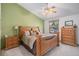 Inviting main bedroom with a vaulted ceiling, a ceiling fan, and traditional wood furniture at 1121 W Kettle Ave, Littleton, CO 80120