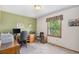 Home office with green accent wall, large window, neutral walls and desk area at 1121 W Kettle Ave, Littleton, CO 80120
