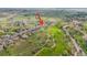 An aerial shot highlights the property's location near a golf course and neighborhood amenities at 42225 Kingsmill Cir, Elizabeth, CO 80107