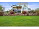 Well-manicured backyard with a stone retaining wall and lush green lawn at 42225 Kingsmill Cir, Elizabeth, CO 80107