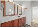 Bathroom with double sink vanity and decorative mirrors at 42225 Kingsmill Cir, Elizabeth, CO 80107