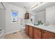 Bathroom features double sink vanity, cabinet storage, and well-lit mirror at 42225 Kingsmill Cir, Elizabeth, CO 80107